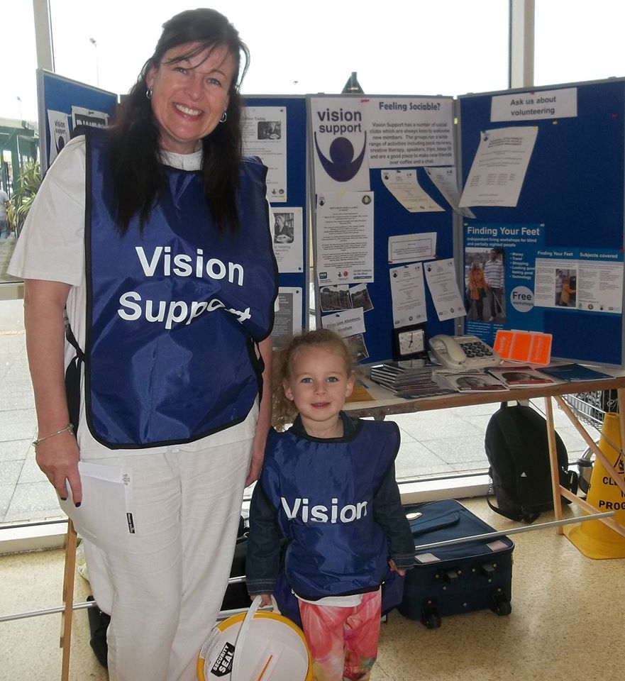 Janette and Izzy infront of Vision Support Stand