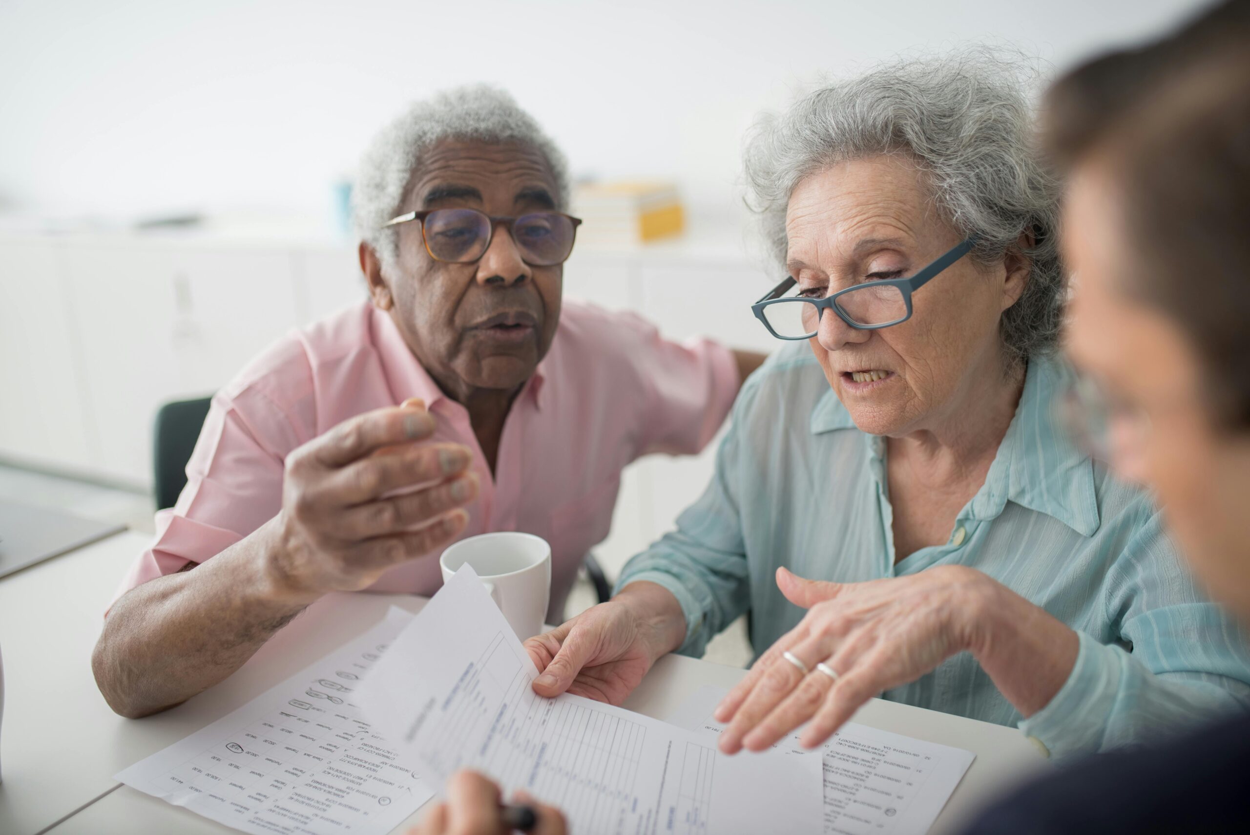 Group of older people discussing financial documents